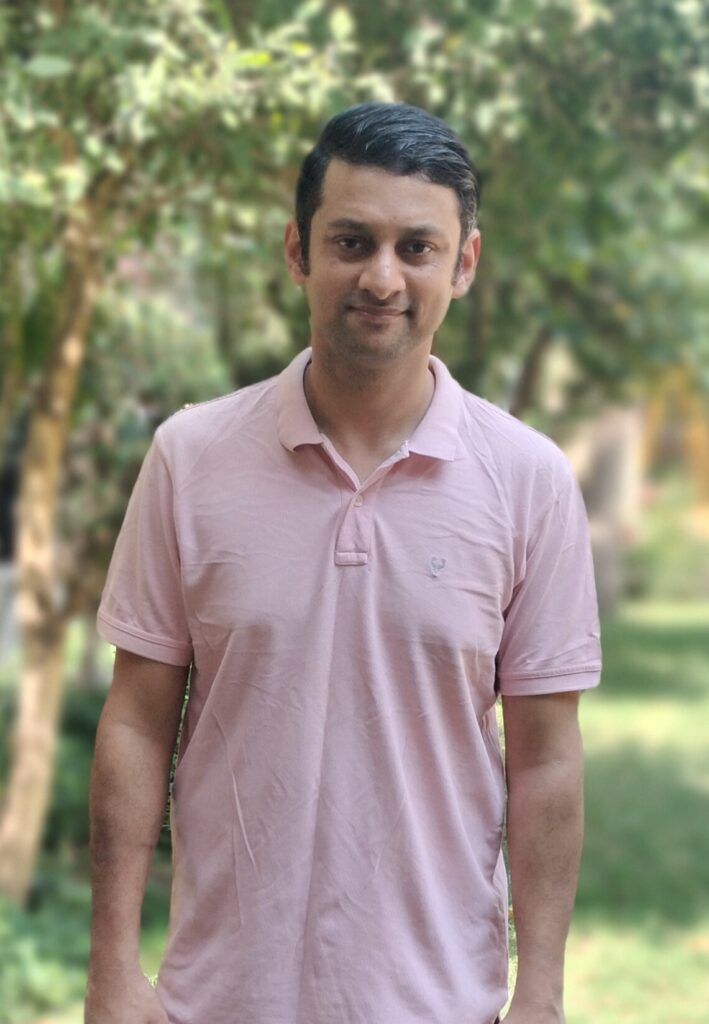 SelfLoversPoint Founder Harshwardhan is standing with a light smile on his face in a calm garden.